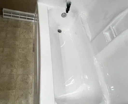 Old worn bathtub restored to a clean and polished finish