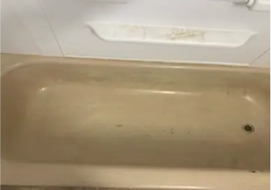 Before Bathtub surface transformed from dull and stained to shiny and clean