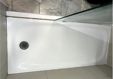 Before shower reglazing with faded grout lines and discoloration