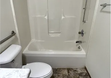 Before shower restoration displaying cracks and stains on tiles