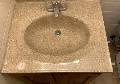 Before sink reglazing showing faded and worn enamel