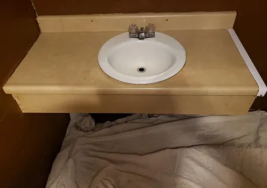 Before sink reglazing showing worn and chipped surface