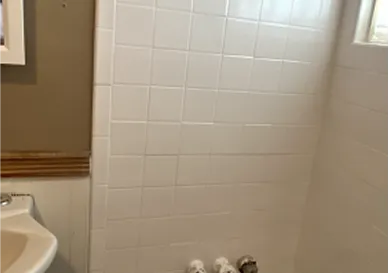 Before tile reglazing showing dull, stained surface and worn-out grout